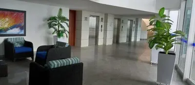 a hallway with chairs and potted plants in a building at Tu lugar favorito en Cartagena in Cartagena de Indias