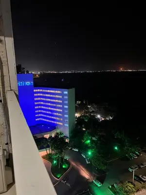 a night view of a large building with blue lights at Bahía Caribe in Estación El Salto