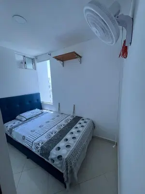 a bedroom with a bed in a room with a light at Bahía Caribe in Estación El Salto