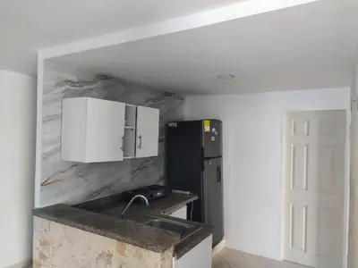 a kitchen with a sink and a refrigerator at Bahía Caribe in Estación El Salto