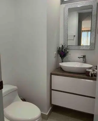 a bathroom with a sink and a toilet and a mirror at Mistral Exclusive oceanfront apartment with balcony in Cartagena de Indias