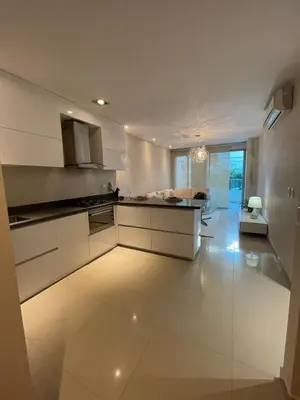a kitchen with white appliances and a large room at Mistral Exclusive oceanfront apartment with balcony in Cartagena de Indias