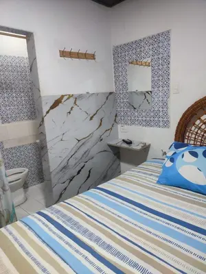 a bedroom with a bed and a toilet at Hostal Marhú in Cartagena de Indias