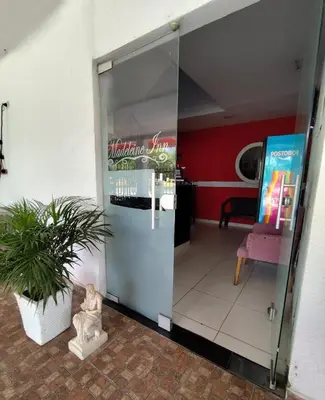 a glass door to a restaurant with a potted plant at Hotel Madeleine Inn Sede Sur in Barranquilla