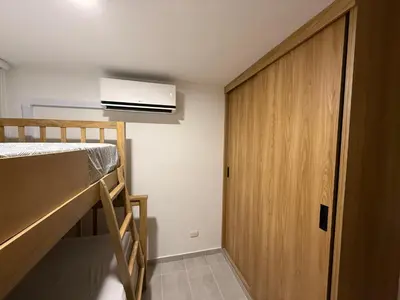 a small room with a bunk bed and a closet at APTO LODGE - Confortable y acogedor apartamento al norte de Barranquilla vía a Puerto Colombia in Barranquilla