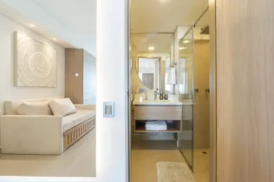 a bathroom with a couch and a sink and a mirror at Suite de Lujo Frente al Mar CB1525 in Cartagena de Indias