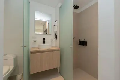 a bathroom with a sink and a toilet and a shower at Suite romántica con terraza lounge y vista panorámica CB834 in Cartagena de Indias