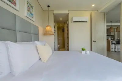 a white bed with white pillows in a bedroom at MQ903 | Jacuzzi & hamaca · Vista espectacular in Cartagena de Indias