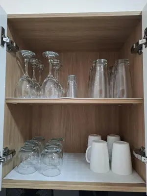 a shelf with glasses and other glass items on it at Baia Kristal - Vacaciones Cartagena Colombia in Cartagena de Indias