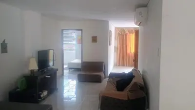 a living room with a couch and a tv at Balcones en Bello Horizonte in Santa Marta