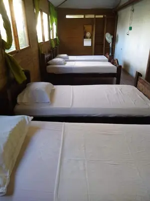 a group of three beds in a room at Casa Hotel Marly in Santa Marta