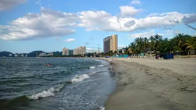 a beach with people swimming in the water at Casa Hotel Marly in Santa Marta