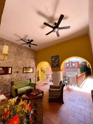 a living room with a couch and a ceiling fan at Hotel Casa Tere in Cartagena de Indias
