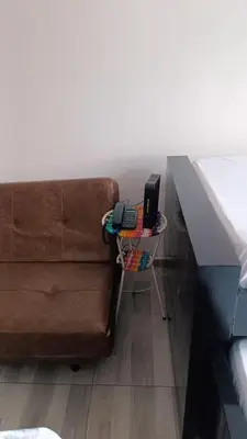 a brown couch with a laptop on a table at Isabela House in Barranquilla