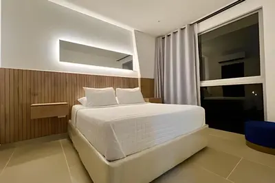 a bedroom with a white bed and a window at Vista a Laguna de Kristal + Bote inflable in Los Arrayanes