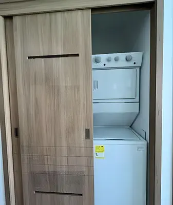 a small kitchen with a refrigerator and a microwave at Vista a Laguna de Kristal + Bote inflable in Los Arrayanes