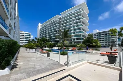 a large building with a pool in front of it at 1 Dormitorio y terraza Morros. Vista mar in Cartagena de Indias