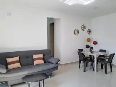 a living room with a couch and a table with chairs at Vacaciones Inolvidables in Coveñas