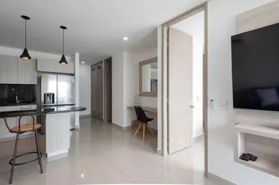 a kitchen and living room with a large mirror at Apartment With Beautiful View In Infinitum in Cartagena de Indias
