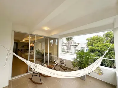 a hammock in a room with a large window at Apartment for 6 Guests in Sabanilla a Few Steps from the Sea in Maizal