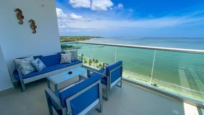 a balcony with blue chairs and a view of the ocean at Magico Apartamento Frente al Mar 3 Habitaciones AR134 in Coveñas