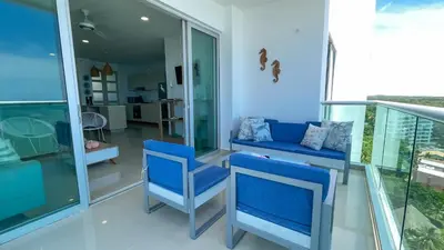 a living room with blue chairs and a couch at Magico Apartamento Frente al Mar 3 Habitaciones AR134 in Coveñas