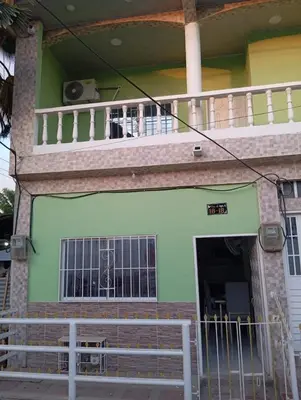 a front view of a house with a balcony at Apartamentos el farol in Ciénaga