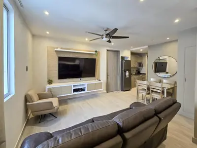 a living room with a couch and a flat screen tv at Moderno apartamento vista al mar y al lago piso 10 in Cartagena de Indias