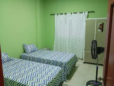 a bedroom with two beds and a window at Apartamentos el farol in Ciénaga