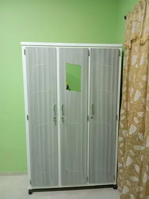 two white cabinets in a room with a curtain at Apartamentos el farol in Ciénaga