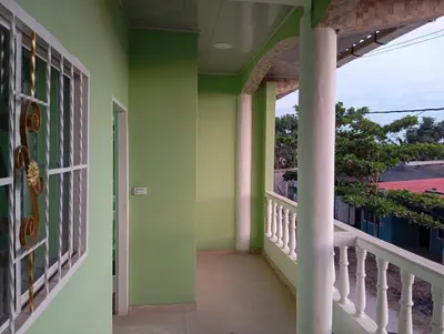 a balcony of a house with green walls at Apartamentos el farol in Ciénaga