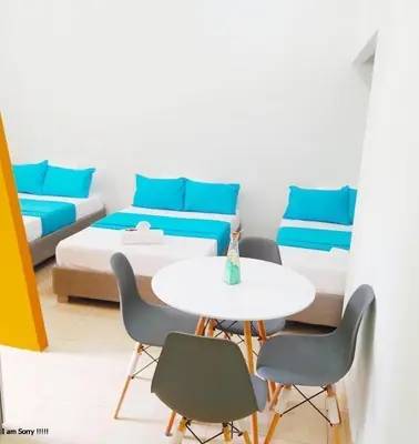 a room with a bed and a table and chairs at alojamiento centro histórico - 3-2 in Cartagena de Indias