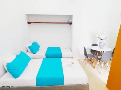 a bedroom with a bed and a table and chairs at alojamiento centro histórico - 3-2 in Cartagena de Indias