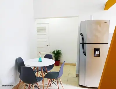 a kitchen with a table and a refrigerator at alojamiento centro histórico - 3-2 in Cartagena de Indias