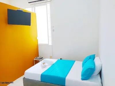 a bedroom with a bed and a tv on the wall at alojamiento centro histórico - 3-2 in Cartagena de Indias