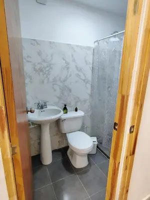 a bathroom with a toilet and a sink at Villa Colibrí in Santa Marta
