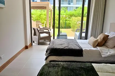 a bedroom with two beds in front of a window at “Lujoso Apto con Piscina, Terraza Privada y Salida a la Playa” in Cartagena de Indias