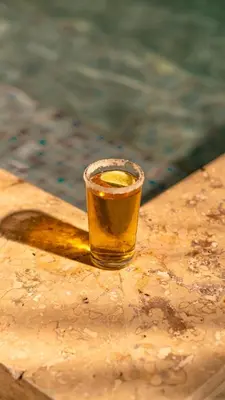a glass of beer sitting on top of a table at Open Sea Hotel Cartagena - Frente al mar in Cartagena de Indias