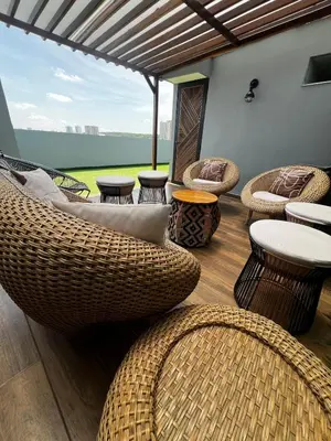 a patio with wicker chairs and tables and a view at Duplex Penthouse Rooftop Lounge in Barranquilla