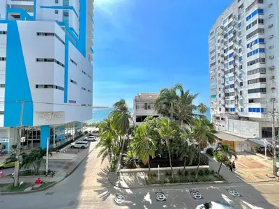 a street in a city with palm trees and buildings at Luxury mediterranean Suite in Cartagena de Indias