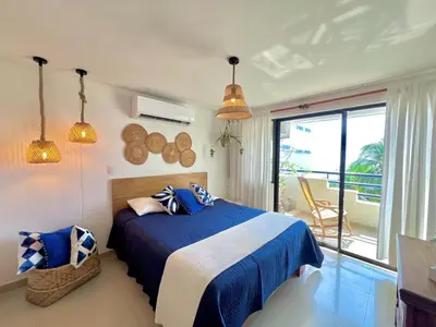 a bedroom with a blue bed and a balcony at Luxury mediterranean Suite in Cartagena de Indias