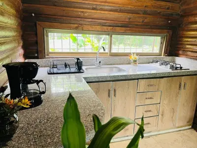 a kitchen with a sink and a window in a cabin at Chalet Palo DAgua in Turbaco