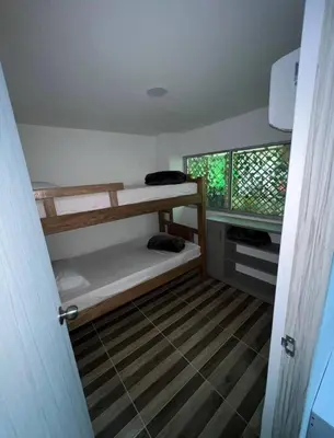 a room with two bunk beds and a window at La Boquilla Oasis - Charming 1-Bedroom Apartment with Pool in Cartagena de Indias