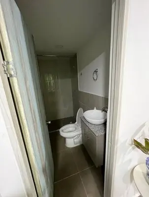 a bathroom with a toilet and a sink at La Boquilla Oasis - Charming 1-Bedroom Apartment with Pool in Cartagena de Indias