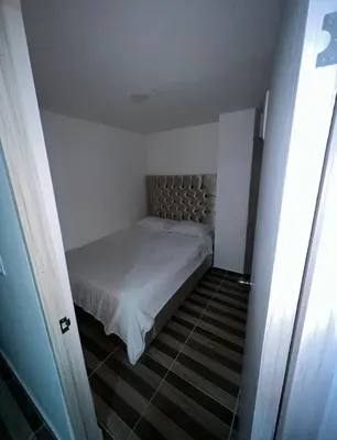 a small bedroom with a bed in a room at La Boquilla Oasis - Charming 1-Bedroom Apartment with Pool in Cartagena de Indias