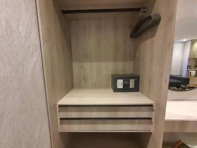 a small clock sitting on a shelf in a room at Moderna suite frente al lago cerca a la playa in Cartagena de Indias