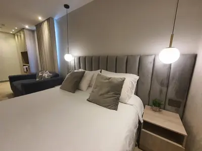 a bedroom with a large white bed with two pillows at Moderna suite frente al lago cerca a la playa in Cartagena de Indias