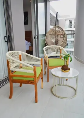 three chairs and a table in a room at Luxury 2-Bedroom Apartment with Breathtaking Ocean Views in Cartagena de Indias