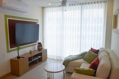 a living room with a couch and a flat screen tv at Luxury 2-Bedroom Apartment with Breathtaking Ocean Views in Cartagena de Indias