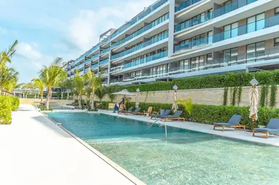 a swimming pool in front of a large building at Luxury 2-Bedroom Apartment with Breathtaking Ocean Views in Cartagena de Indias